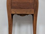 an image of a small wooden table with a drawer on it