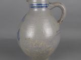 a white and blue vase sitting on a table
