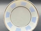 an image of a blue and white plate sitting on top of a table