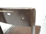 a close up of a metal chair with a leather seat