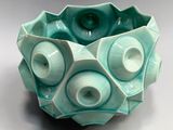 a blue bowl that has a bunch of holes in it