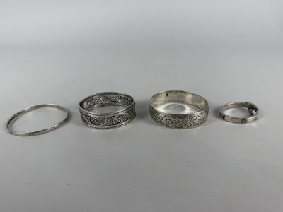 three silver rings and a silver ring on a white surface