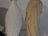 two statues of jesus and a woman standing next to each other