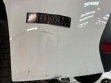 a sticker on the back of a white car