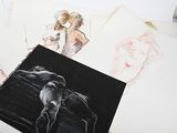 many drawings of a woman and a man on a table