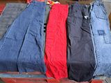 three pairs of jeans sitting on top of a pallet