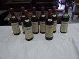 several bottles of wine are lined up on a table