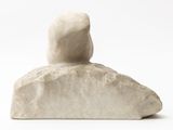 marble sculpture of a person sitting on a rock on a white background
