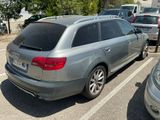 a silver car parked in a parking lot next to other cars