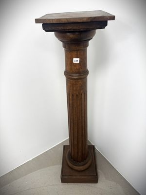 an image of a wooden pedestal with a sign on top of it