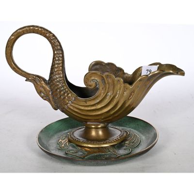 an image of a gold and green teapot on a saucer