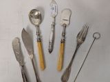 five different types of silverware on a white surface