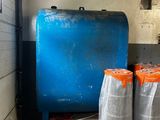 two large blue barrels sitting next to each other in a room