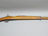 an old rifle with a wooden barrel and a wooden handle