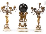 three antique figurines with a black globe on top of them
