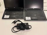 two laptops that are sitting on a white table