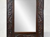 an old wooden mirror with a carved frame on a white background