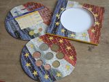 three coasters with coins on them sitting on a table