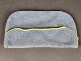 a close up of a gray and yellow eye mask on a brown surface