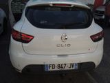 a white car parked in a parking lot with other cars