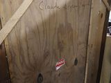 a wooden cabinet with a sign on it in a room