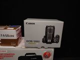 two canon eos cameras sitting on top of each other on a table