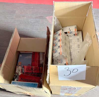 a cardboard box filled with books and magazines on a table