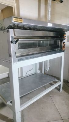 an oven that is sitting on a stand in the kitchen