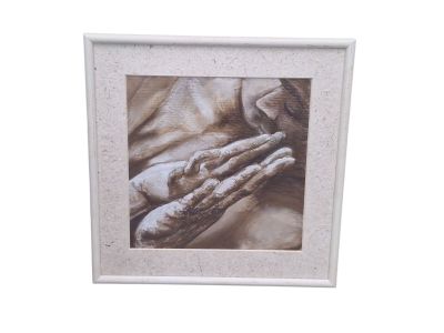 painting of a praying hand in a white frame on a white background