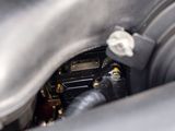 a close up of a car ' s engine with a clock on it