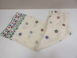 two pieces of white cloth with colorful flowers and snowflakes on them