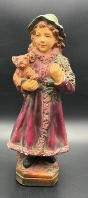 figurine of a little girl holding a cat and a dog
