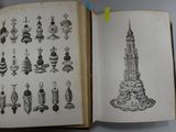 an open book with a drawing of a tower in it