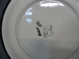 a white plate with a black border and a white plate with a black border and a white plate with a black border and a white plate with a black