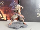 a figurine of a man with a sword in front of a box