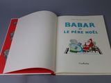 an open book with a picture of a santa claus on a sleigh