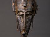 a close up of a sculpture of a head on a stand