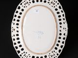 a close up of a white plate with holes on it