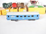 several toy trains are lined up next to each other on a white surface