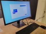 a computer on a desk with a keyboard and mouse