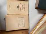 several old books are stacked on top of each other on a table