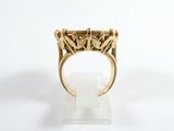 an image of a gold ring on a white surface