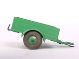 a green toy truck that is sitting on a white surface