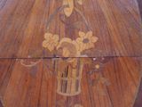 a wooden table with a vase of flowers on top of it