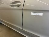 a silver car with a sticker on the side of it