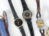 a lot of watches that are sitting on a table
