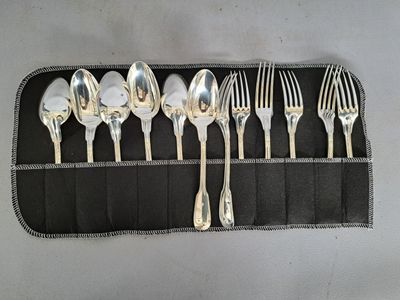 five silver spoons and six silver spoons in a black case
