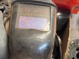 an image of a welding helmet sitting on top of a pile of tools