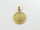 a close up of a gold coin on a white surface