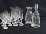 a group of wine glasses and a decanter on a table